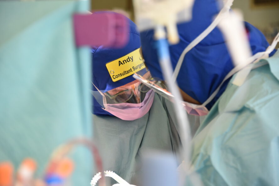 Two surgeons wearing the Eco Ninjas badges in surgery.